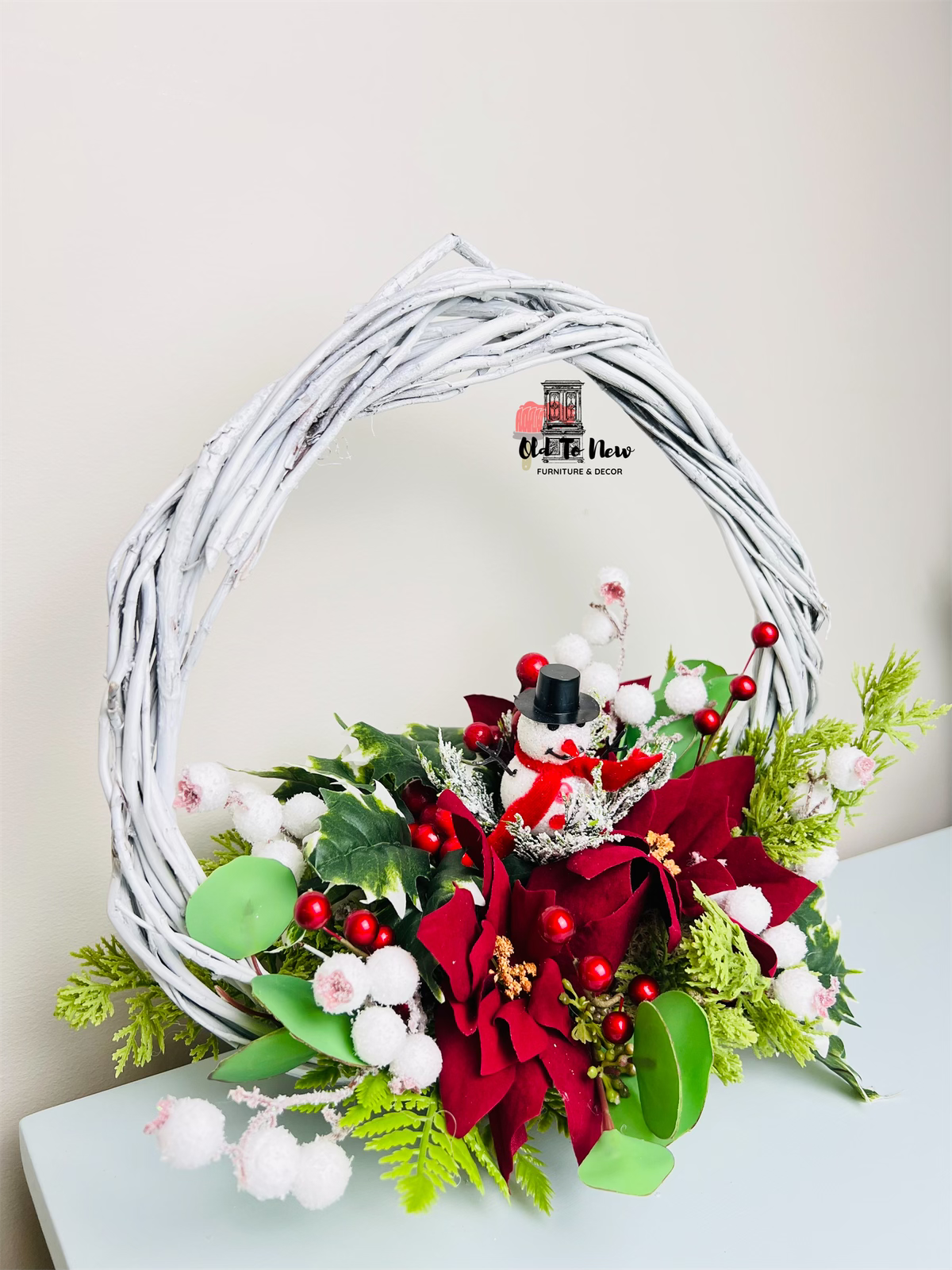 Christmas arrangement, red white and green flowers with snow man