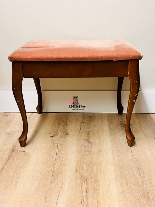 Unfinished wooden bench with pink cushion on a wooden floor against a white wall, available for customization 