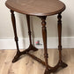 Wooden side table with a round top and elegant legs on a wooden floor, available for customization 
