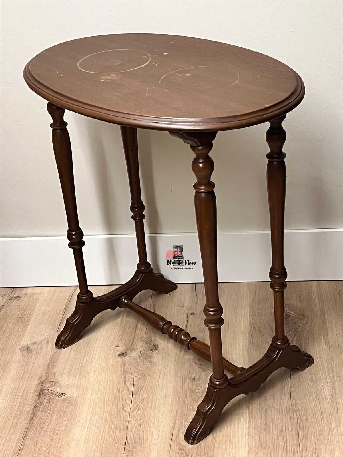 Wooden side table with a round top and elegant legs on a wooden floor, available for customization 