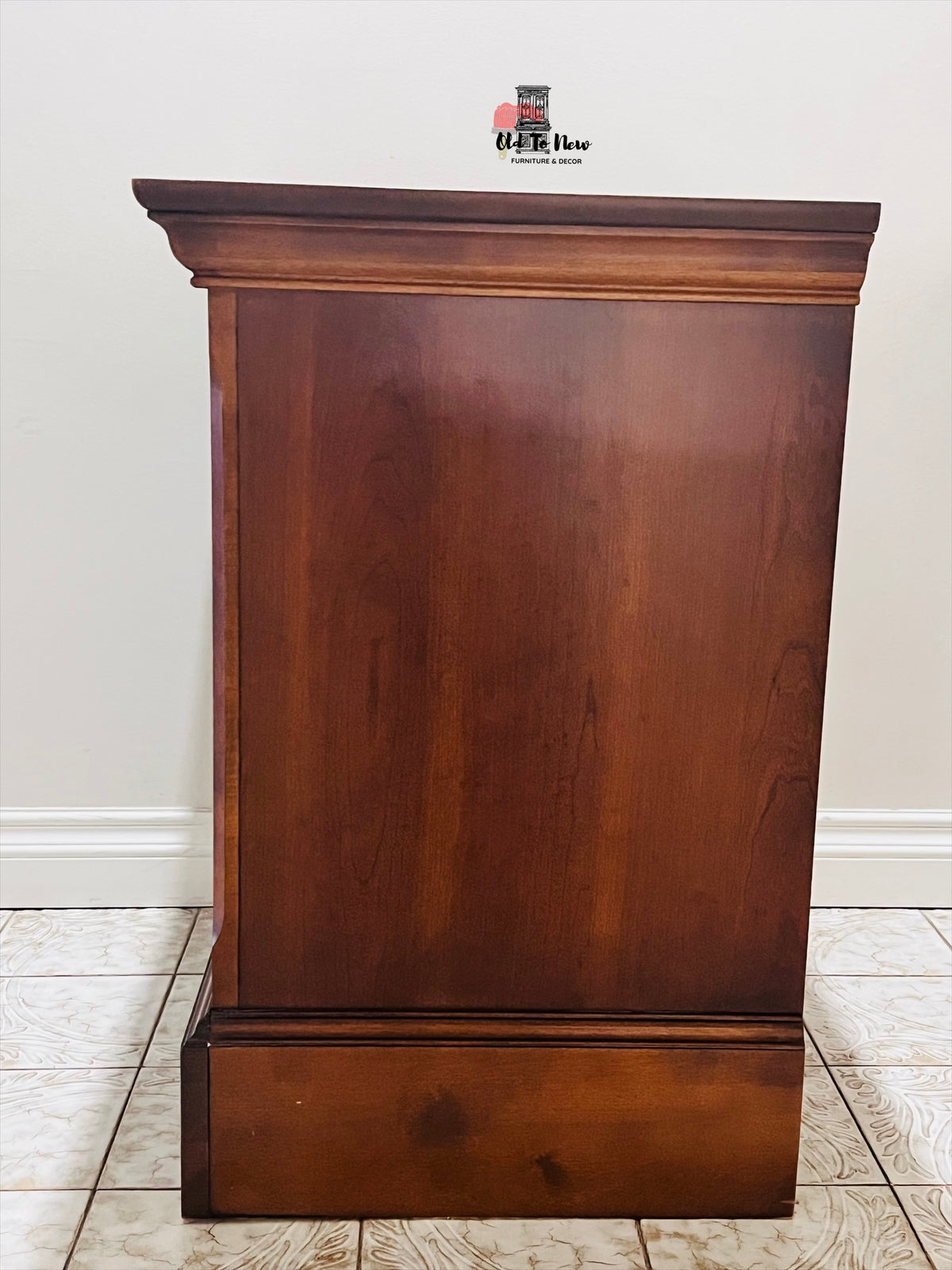 Wooden end table against a white wall