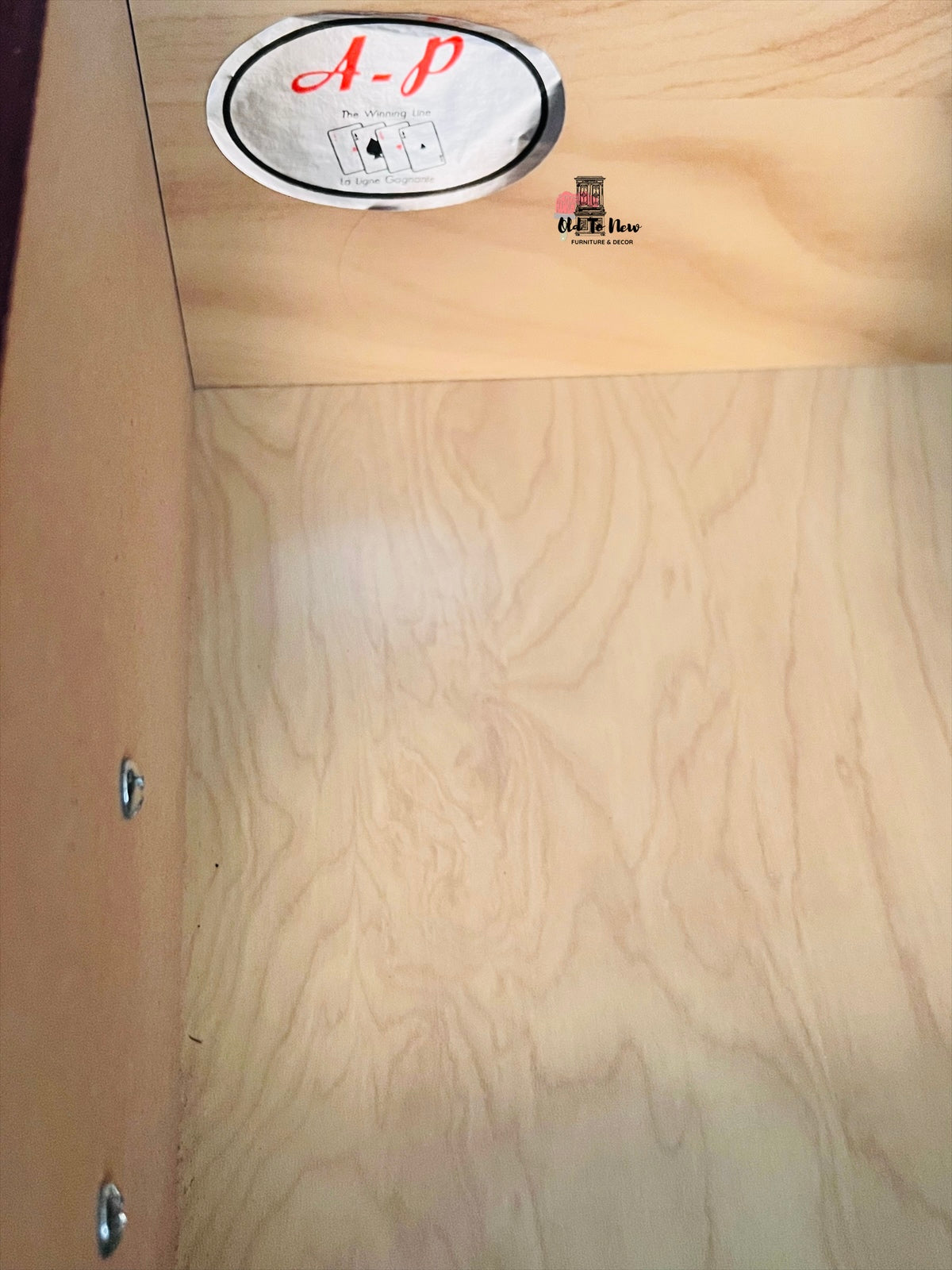 Wooden surface with a circular A-P logo and text.