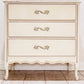 French Provincial dresser with decorative handles on a tiled floor.