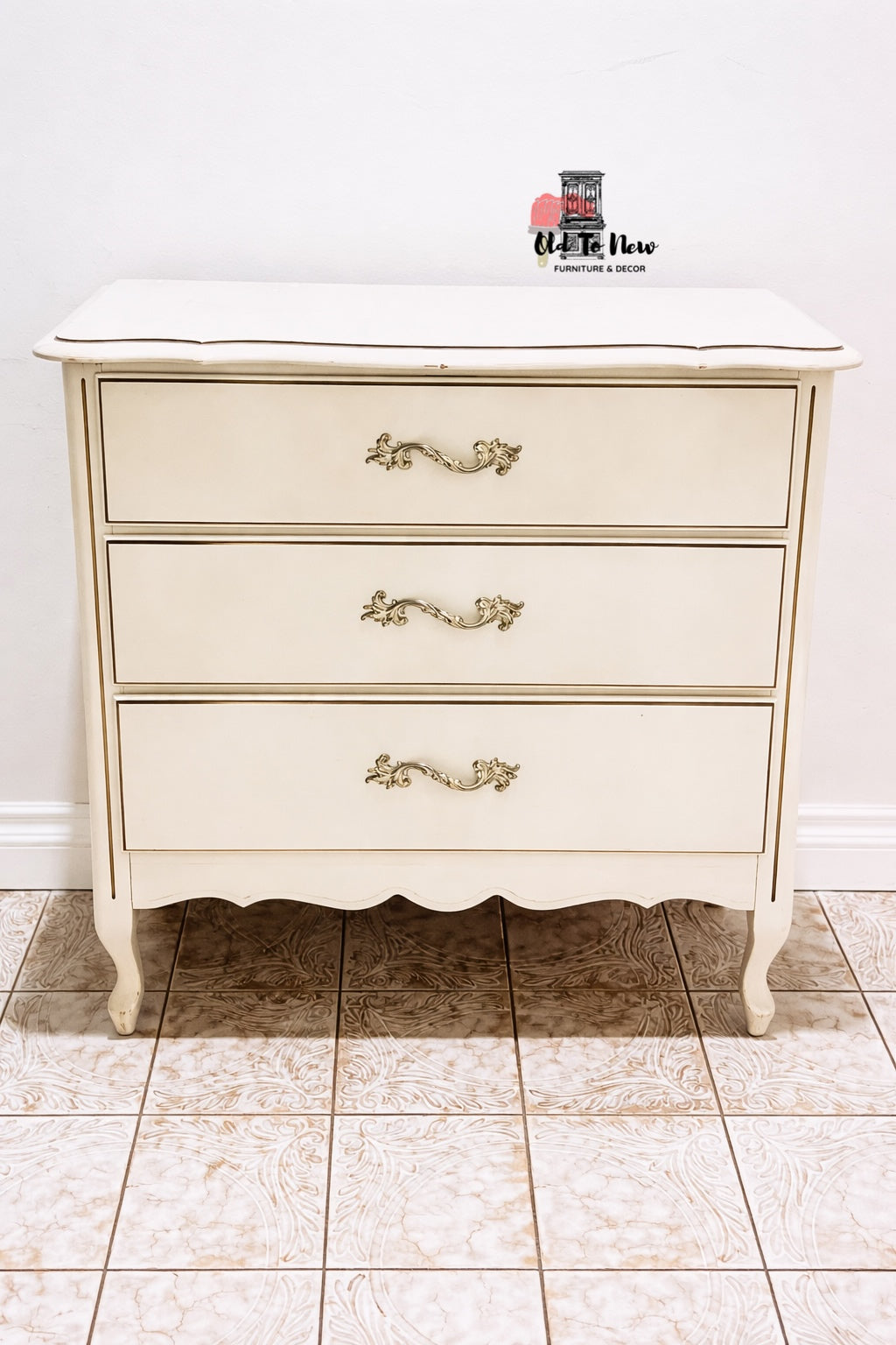 French Provincial three-drawer dresser with decorative handles.