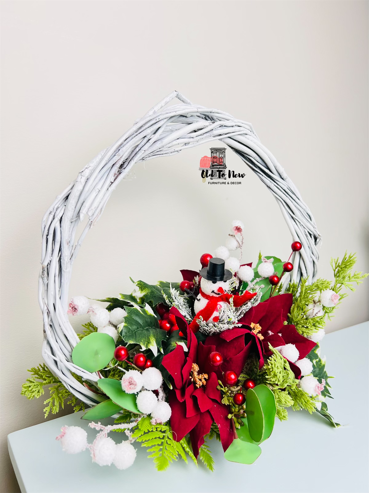 Christmas arrangement, red white and green flowers with snow man 